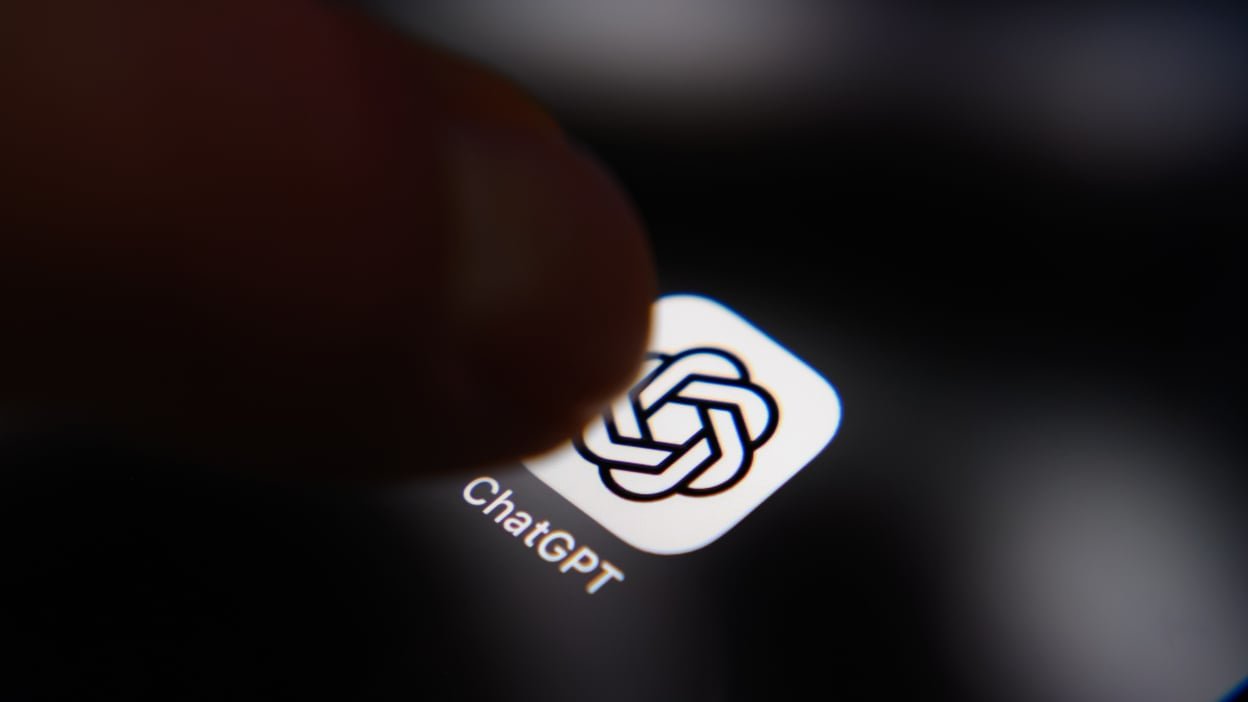 A finger hovers over the ChatGPT app on a screen.