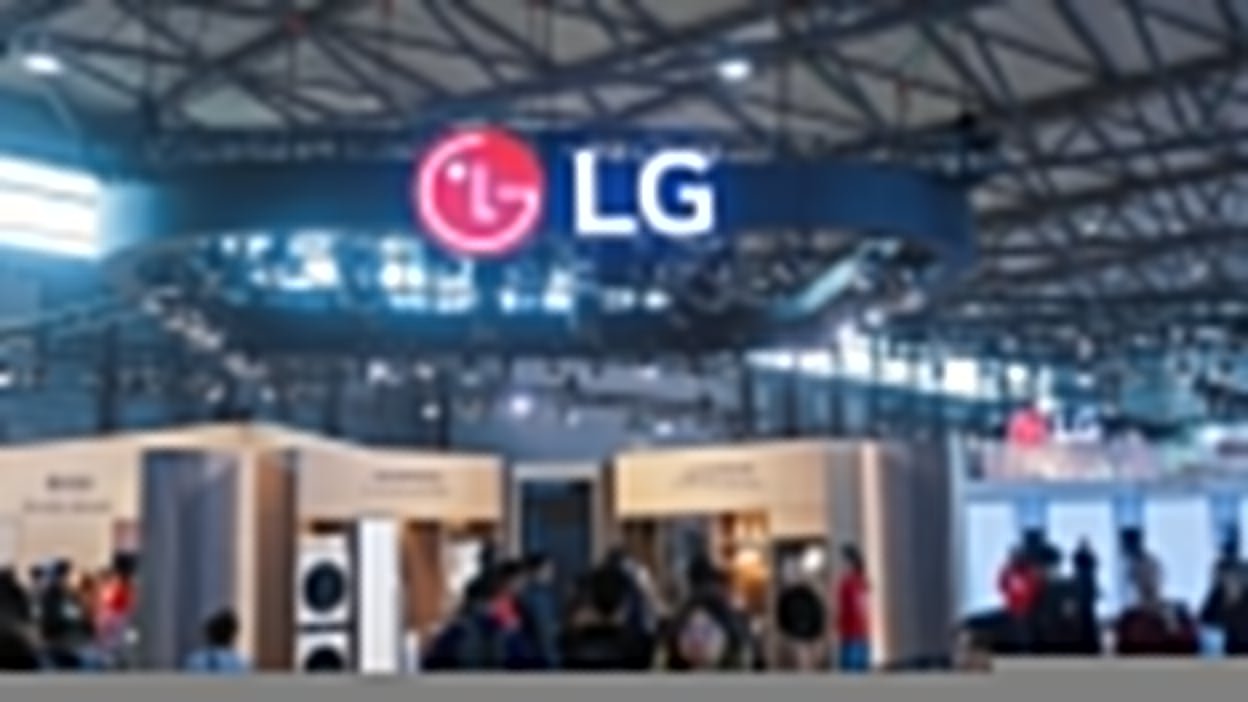 A visitor visits the LG Smart White Goods exhibition area, featuring washing machines, refrigerators, and air conditioners