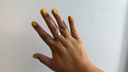 A hand wearing an Oura Ring 5